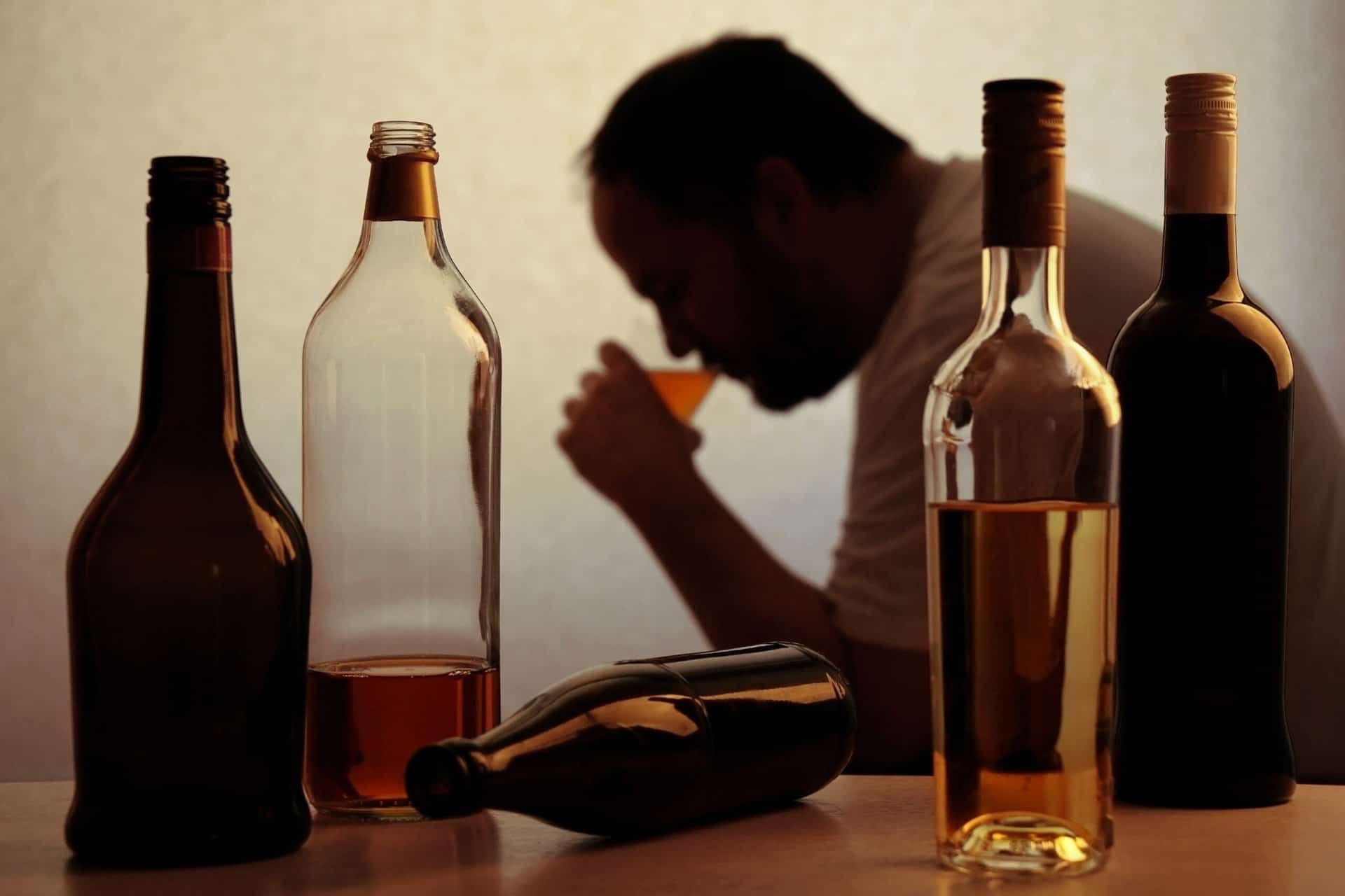 man drinking alcohol and struggling with alcohol abuse