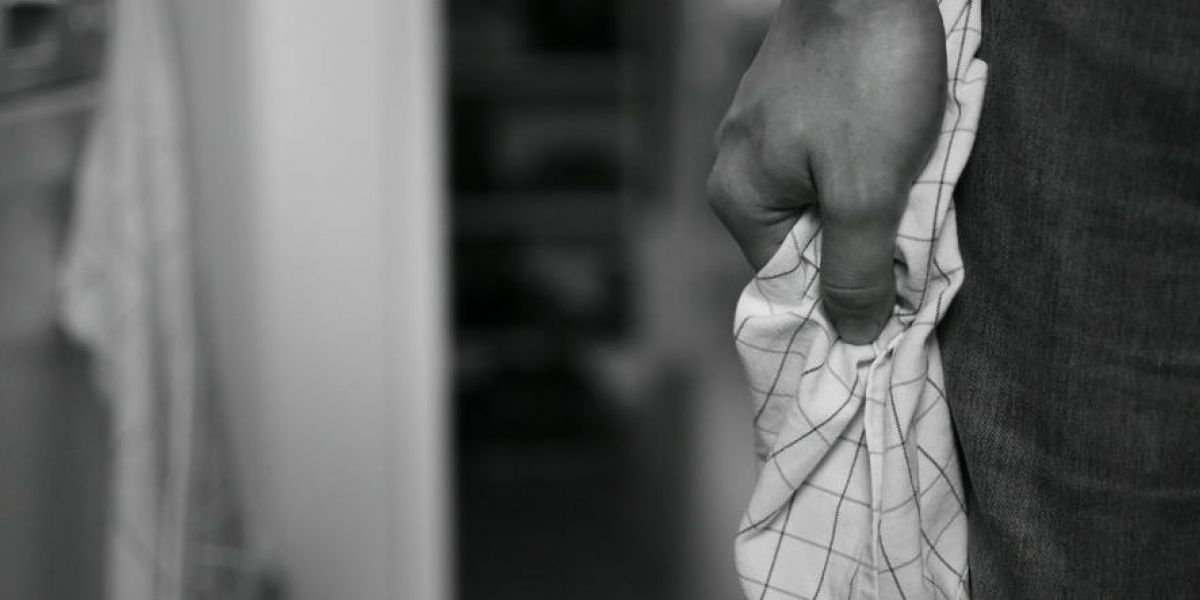 man gripps a towel tightly as he attempts to control his anger