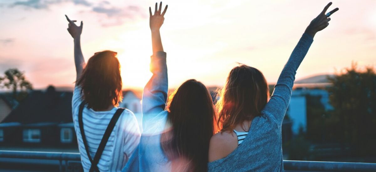 three girls with their back turned celebrate being freed from addiction through substance abuse treatment