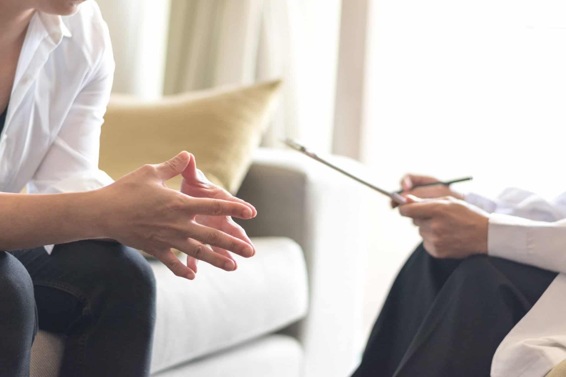 person beginning stages of addiction recovery by talking to an intake counselor at a rehab center