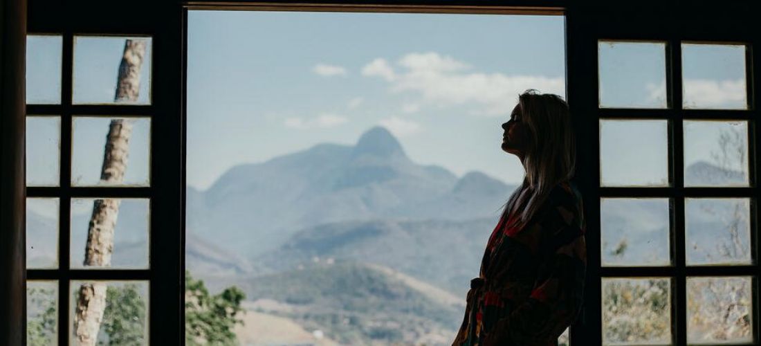 Girl looks out to a mountain grateful for recovery from drugs