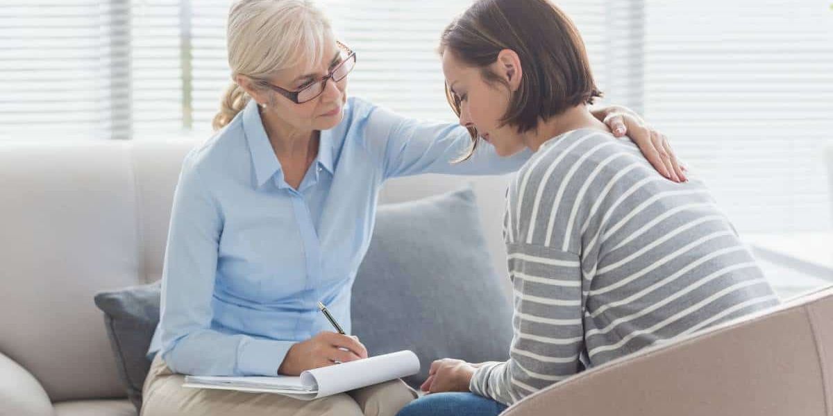 Female patient receiving support and advice from therapist during rehab in Chattanooga, TN.