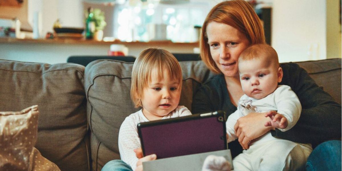 mother and her two daughters spend time together in the living room