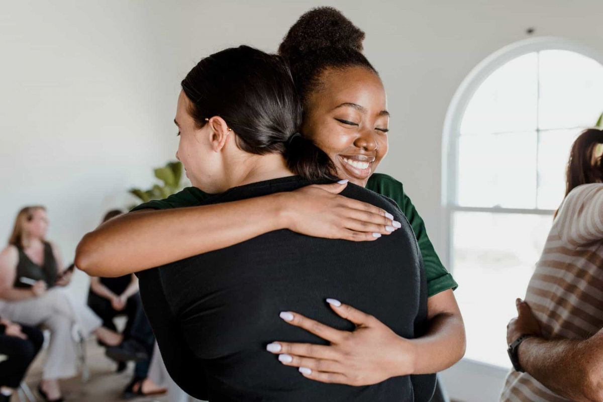 two women hugging at the group therapy