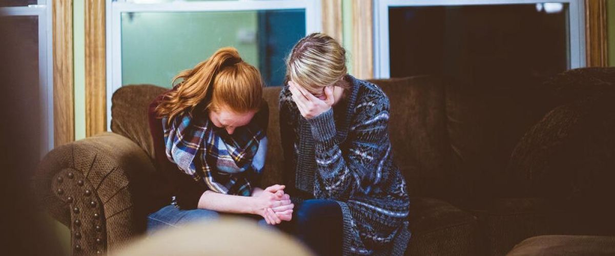 a mother and daughter embrace each other as one struggles with mental health